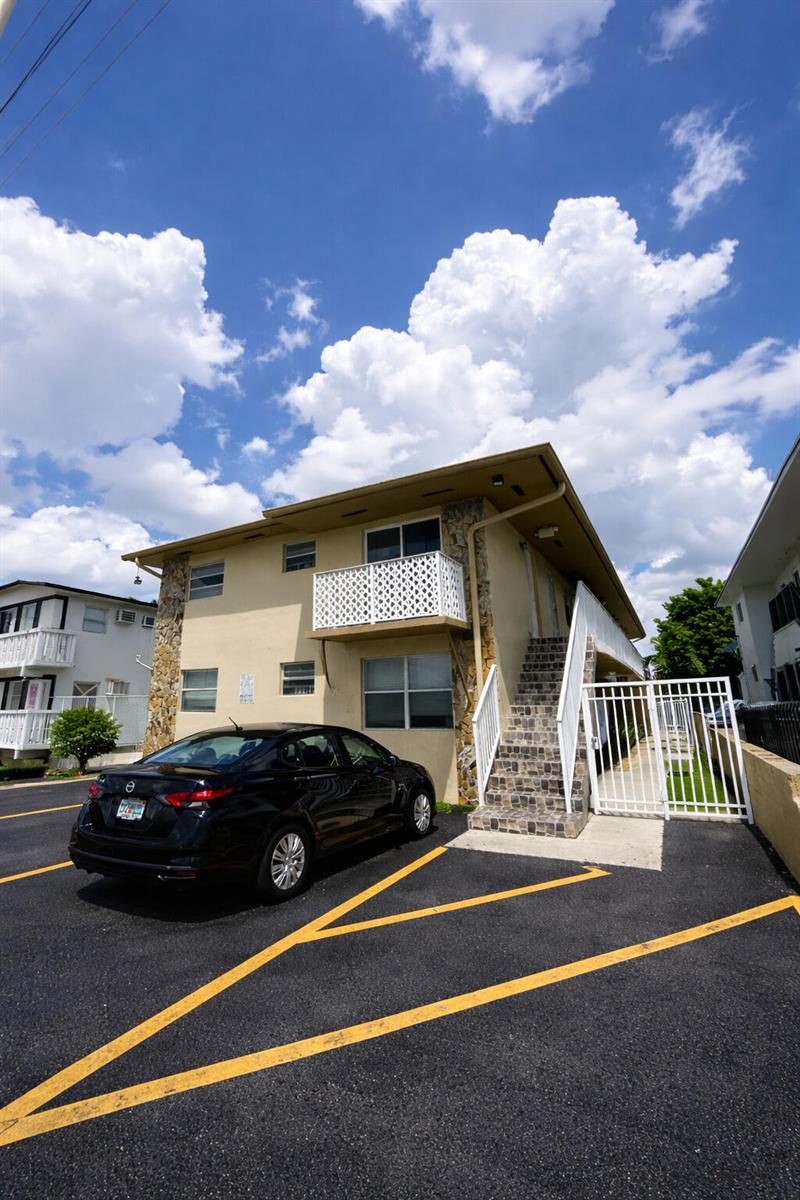 A two-story apartment building with a black car parked in the front lot — 715 W 29th Street, Hialeah FL 33012, HIALEAH, FL