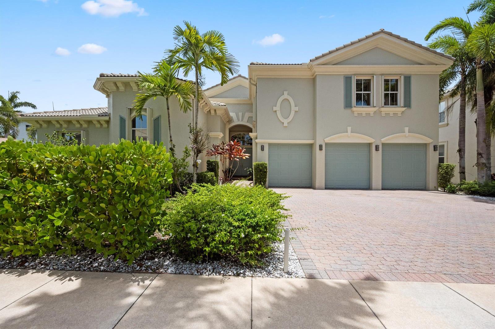 A two-story house with a three-car garage, light-colored stucco exterior, and a paved driveway — 2792 Pillsbury Way, Wellington FL 33414, WELLINGTON, FL