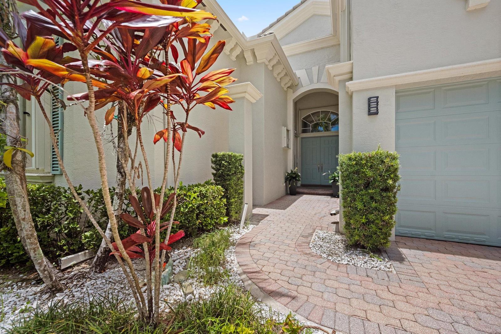 A brick walkway leads to the front entrance of a house with a light-colored exterior — 2792 Pillsbury Way, Wellington FL 33414, WELLINGTON, FL