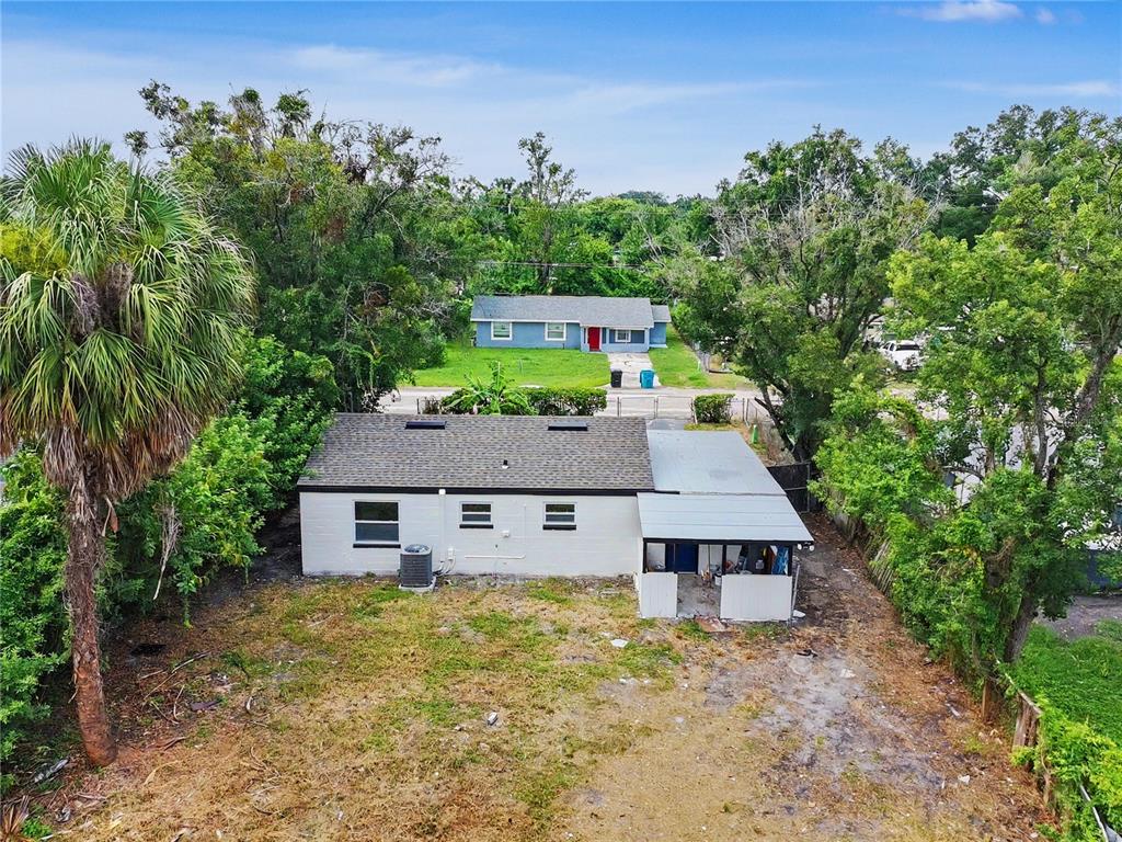 An aerial view of a single-story house with a metal-roofed patio and a large yard — 2848 W HARWOOD STREET, ORLANDO, FL
