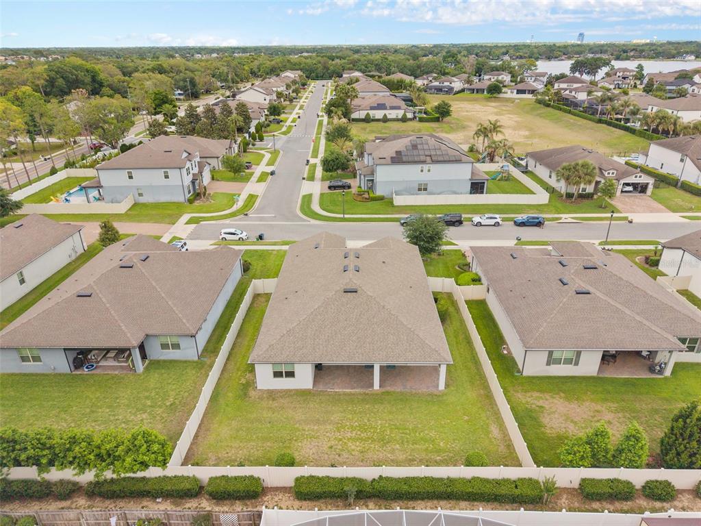 An aerial view shows the backyards and roofs of several suburban houses in a neighborhood — 284 ISLAND SOUND COURT, LONGWOOD, FL