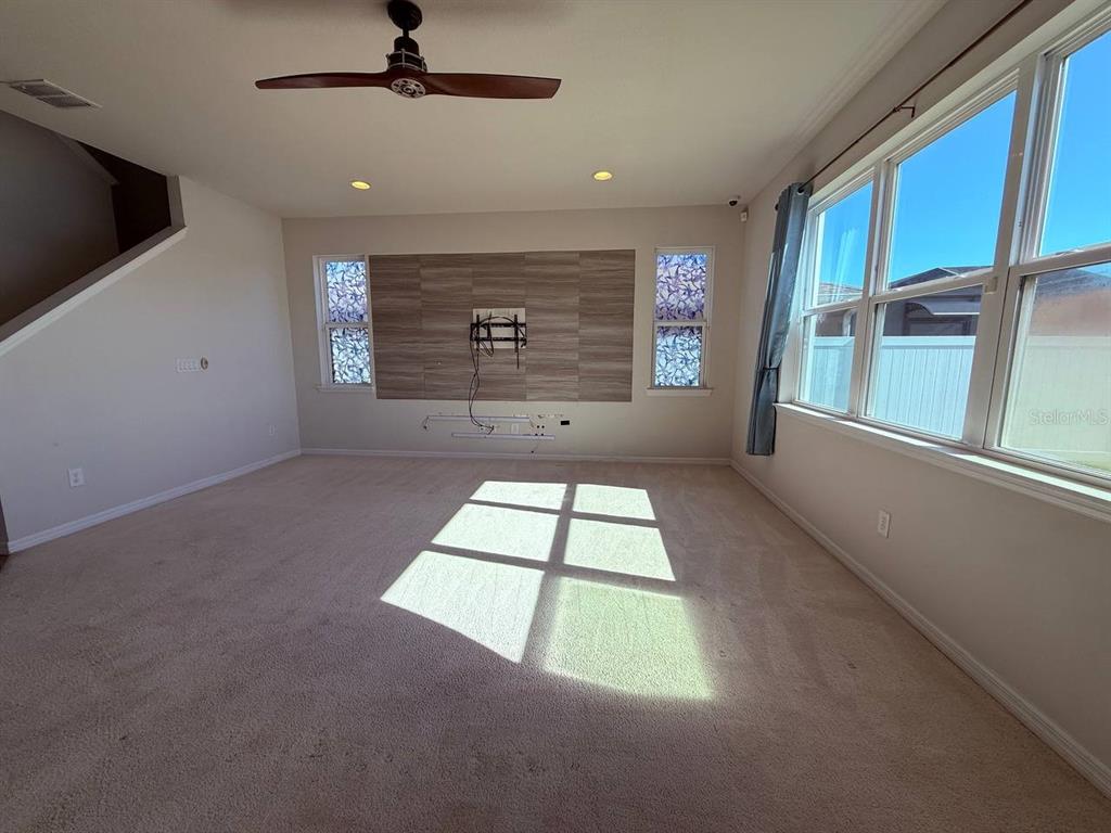 A two-story light blue house with a palm tree in the front yard — 14112 POKE RIDGE DRIVE, RIVERVIEW, FL