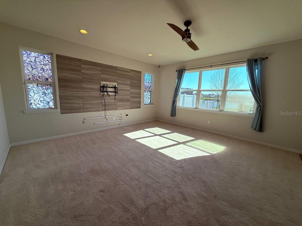 A two-story light blue house with a two-car garage and a palm tree in front — 14112 POKE RIDGE DRIVE, RIVERVIEW, FL
