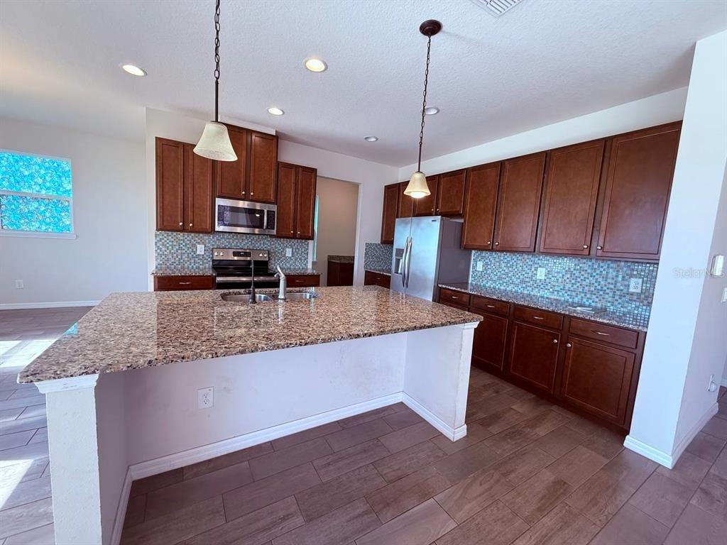 An empty bedroom features beige carpeting, light-colored walls, and two windows with brown curtains — 14112 POKE RIDGE DRIVE, RIVERVIEW, FL