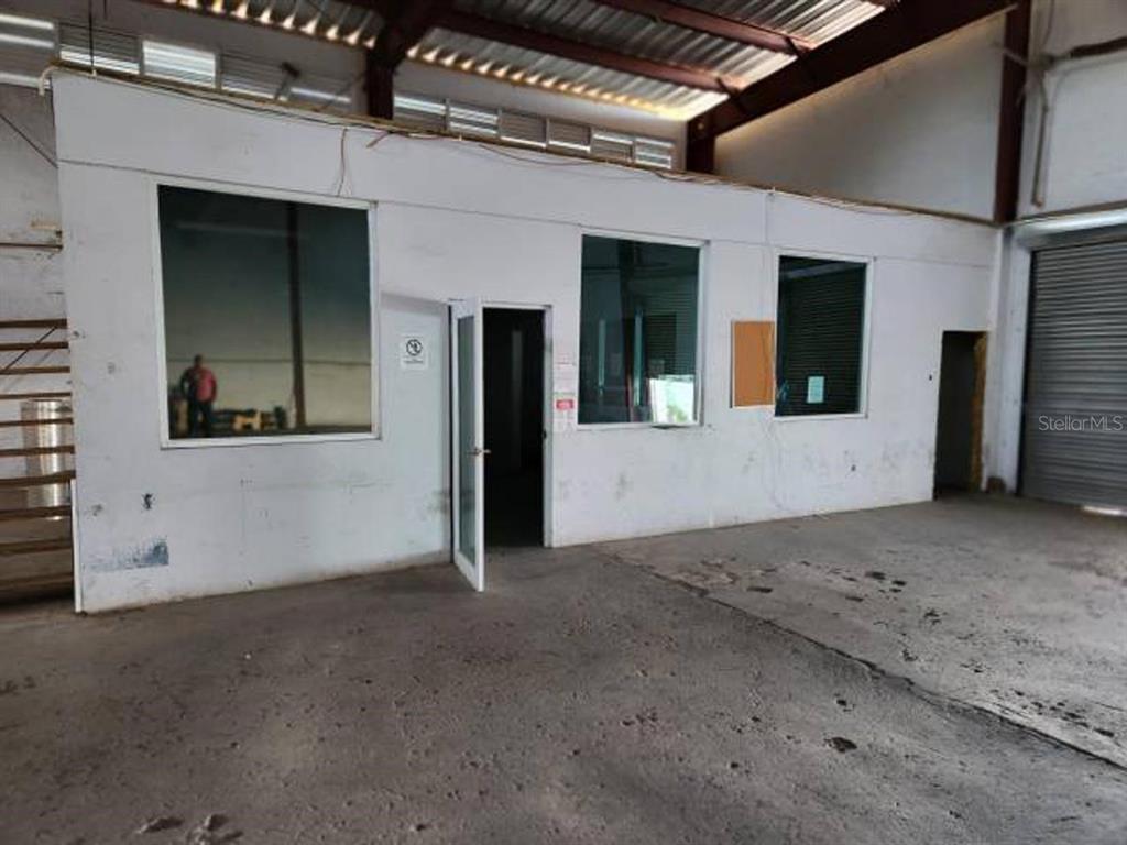 An interior view of a warehouse featuring a white office structure with windows and doors — 20 REPARADA INDUSTRIAL PARK, 4TH ST. LOT 20, PONCE, PR