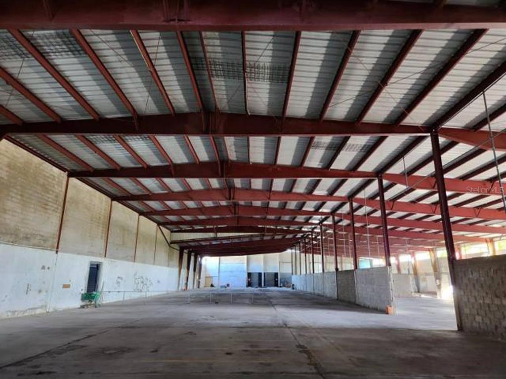 An expansive, empty industrial warehouse space with a high metal roof and concrete flooring — 20 REPARADA INDUSTRIAL PARK, 4TH ST. LOT 20, PONCE, PR