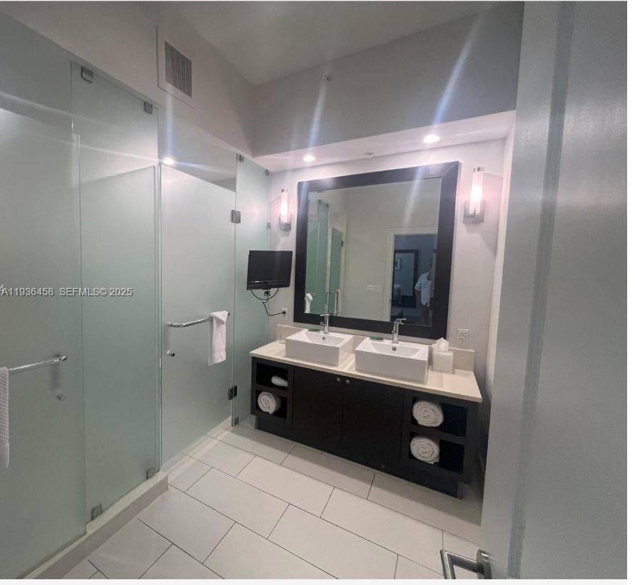 A modern bathroom features a double vanity with vessel sinks and a glass-enclosed shower — 5300 NW 87th Ave # 601, Doral FL 33178, DORAL, FL