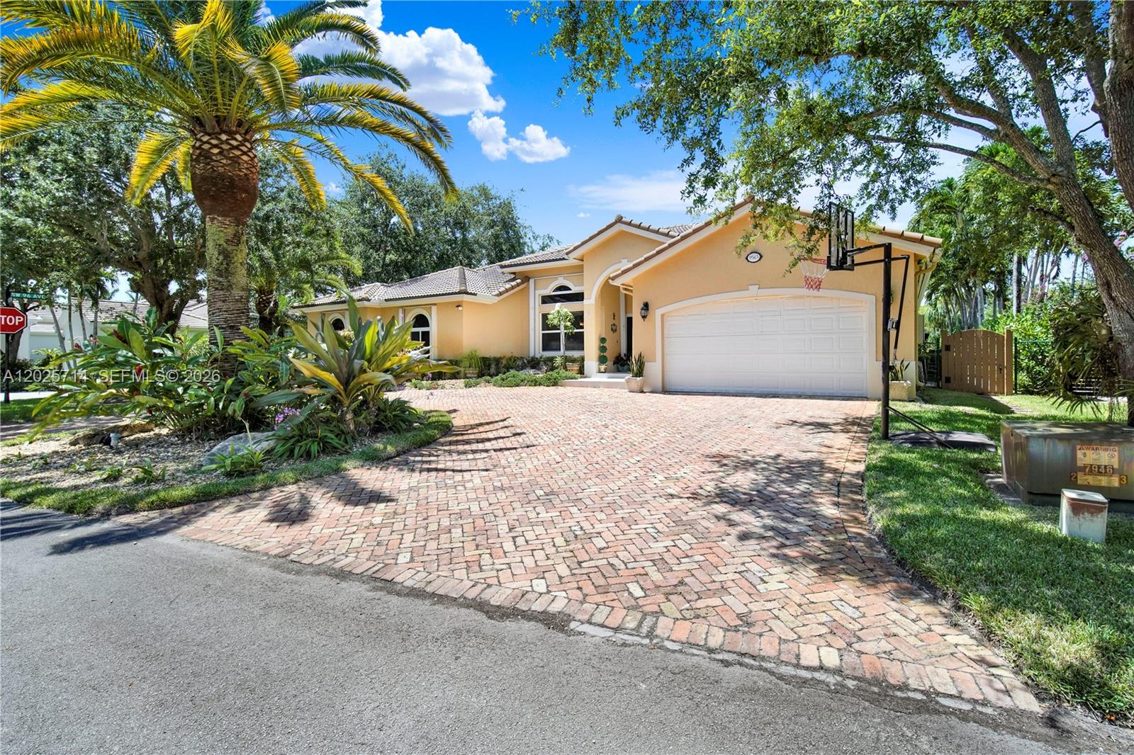 A single-story house with a brick driveway, a two-car garage, and a palm tree — 9563 SW 123rd Ter, Miami FL 33176, MIAMI, FL