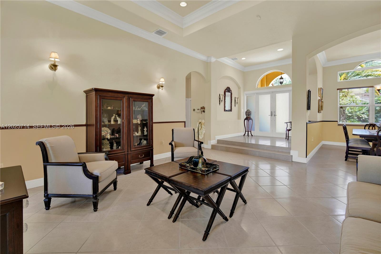 A living room with tile floors, a coffered ceiling, and a raised entryway with double doors — 9563 SW 123rd Ter, Miami FL 33176, MIAMI, FL