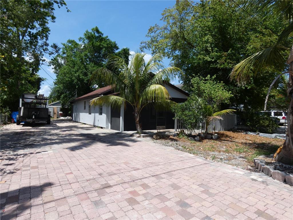 A paved driveway leads to a single-story house with a palm tree and screened porch — 3817 PEARL STREET, FORT MYERS, FL