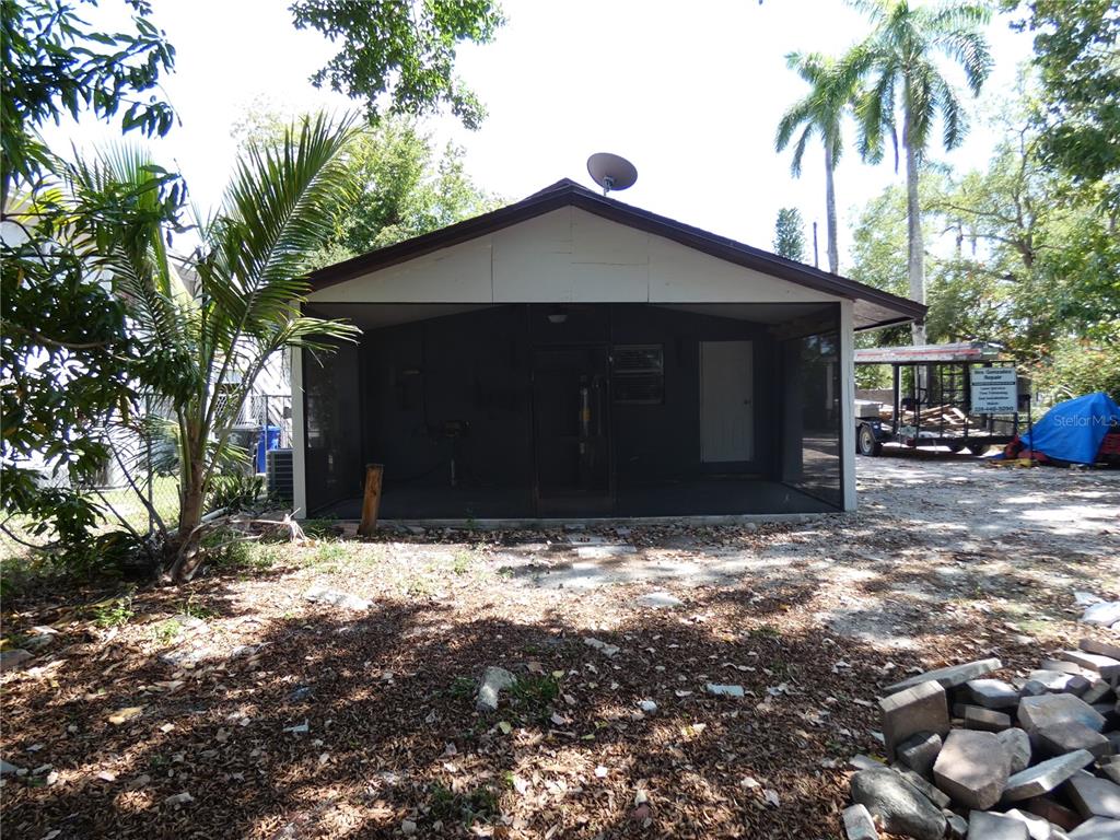 A screened-in porch is attached to the rear of a house with a gabled roof — 3817 PEARL STREET, FORT MYERS, FL