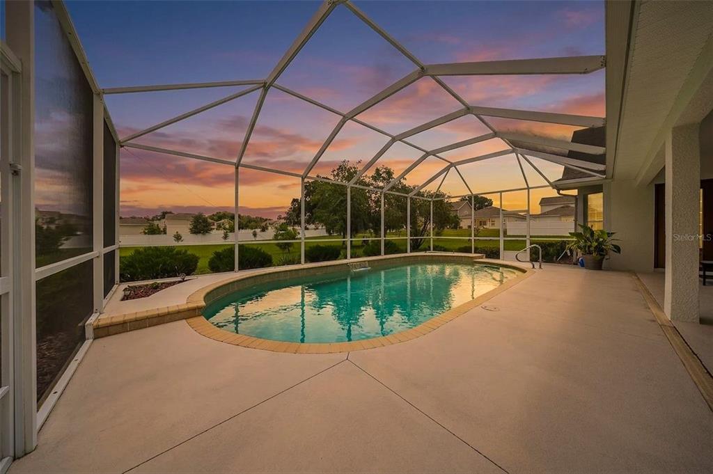 A single-story white house with a gray shingled roof sits on a grassy lot — 5092 NE 81ST BOULEVARD, WILDWOOD, FL