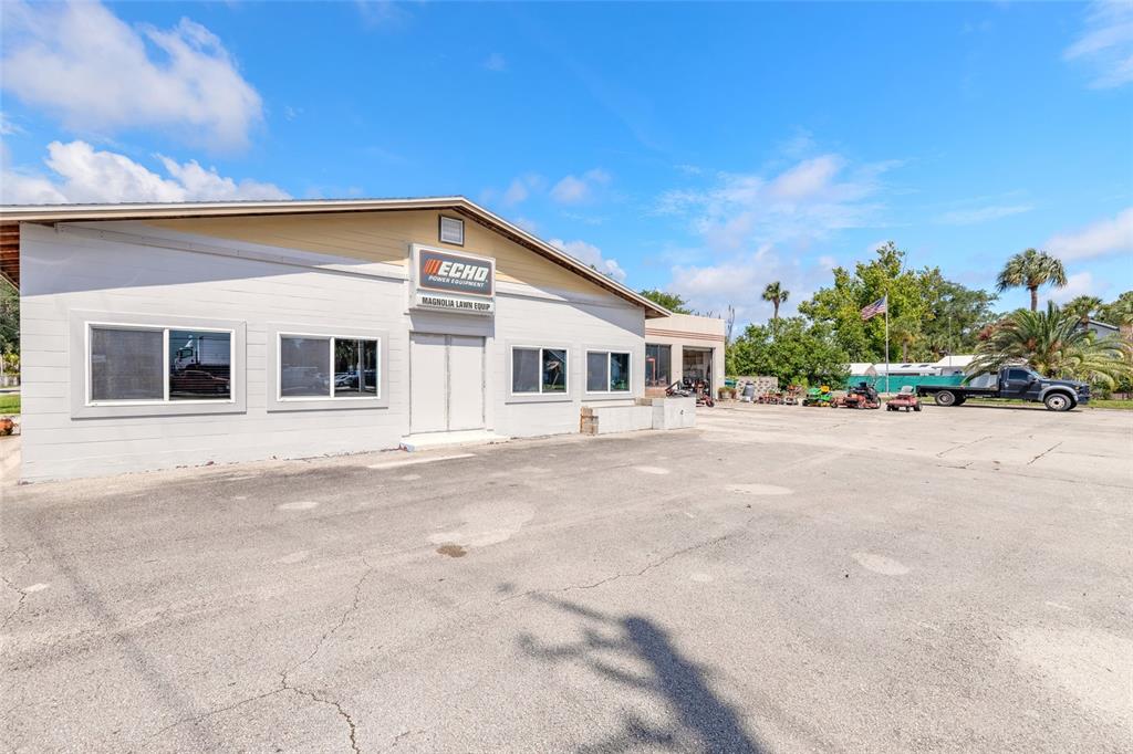 A light-colored commercial building with an Echo sign sits on a large paved lot — 600 N DIXIE FREEWAY, NEW SMYRNA BEACH, FL