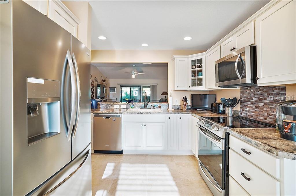 A kitchen with white cabinets, stainless steel appliances, and granite countertops — 3225 WISE WAY, THE VILLAGES, FL