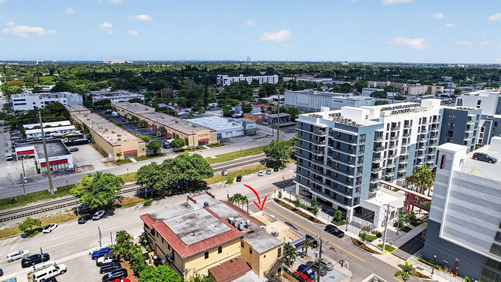 An aerial view shows a low-rise building with a red roof next to a modern apartment complex — 2040 Polk Street, Hollywood FL 33020, HOLLYWOOD, FL