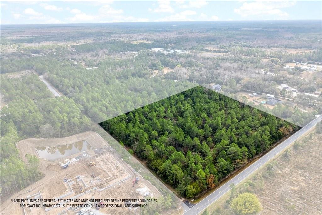 An aerial view shows a rectangular, tree-covered plot of land adjacent to a road — 0 OLD HAW CREEK ROAD, BUNNELL, FL