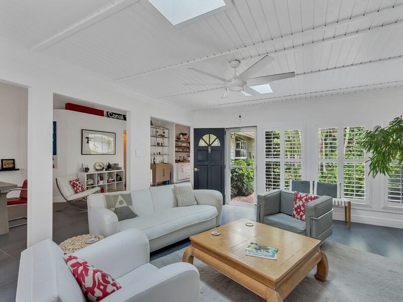 A bright living room features white walls, a wood-paneled ceiling, and a wooden coffee table — VERO BEACH, FL