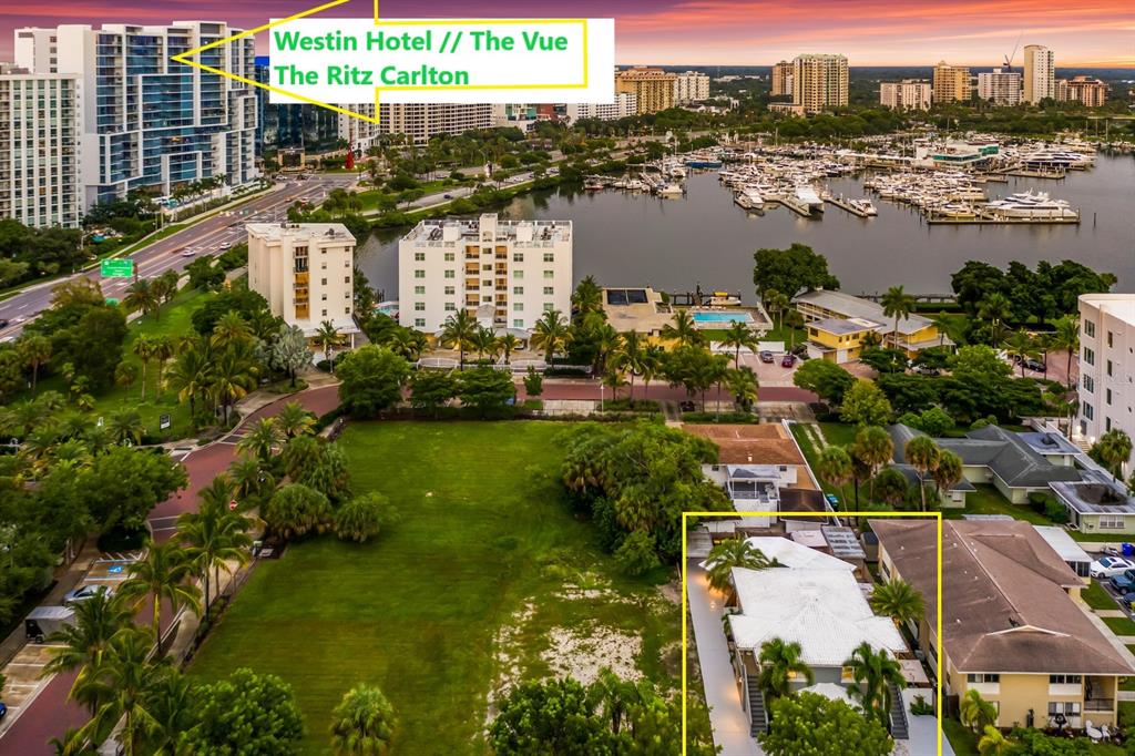 An aerial view shows a large vacant lot, nearby residential buildings, and a marina — 161 GOLDEN GATE POINT, SARASOTA, FL