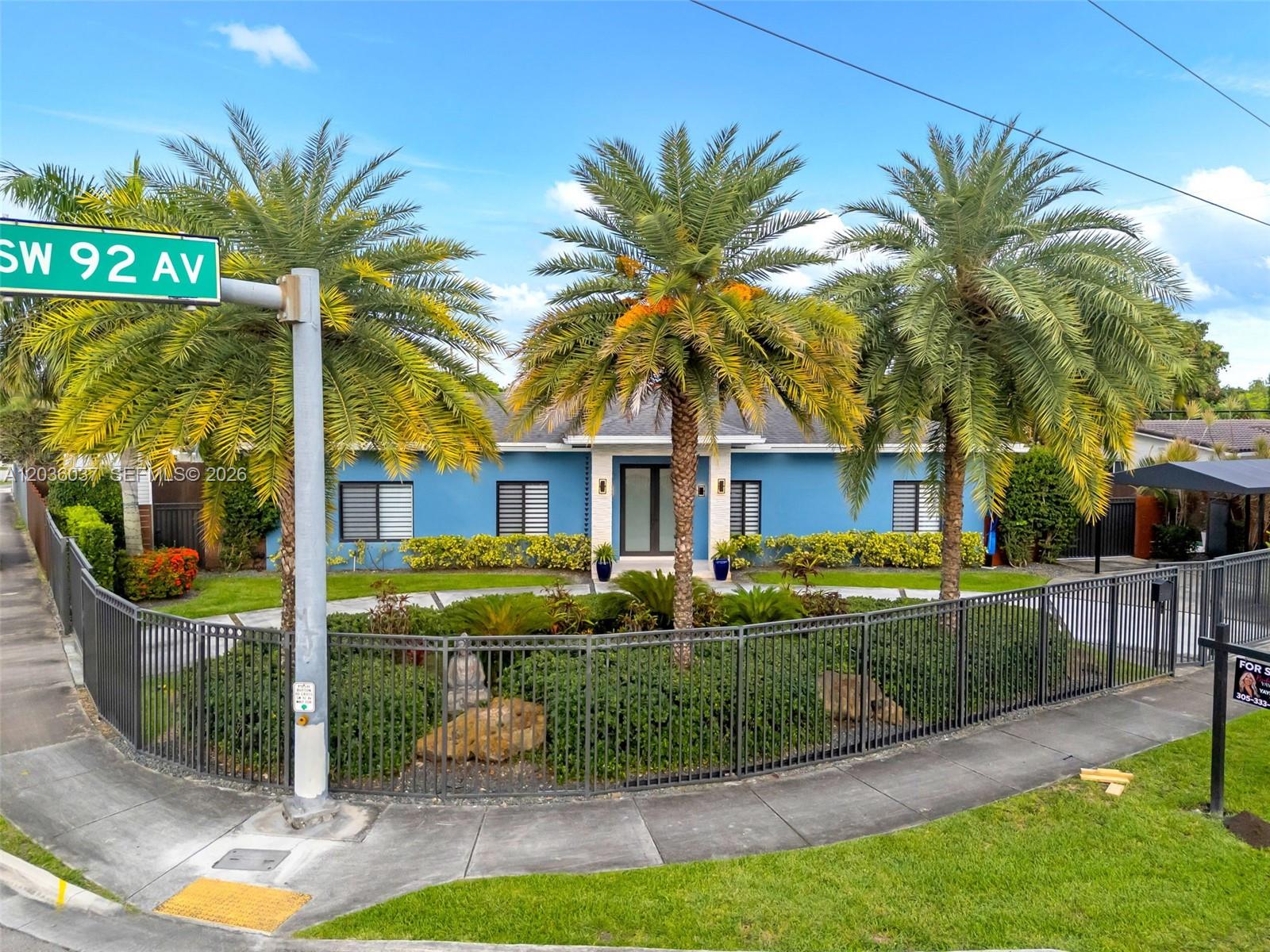A blue single-story house features three palm trees and a fenced front garden — 1201 SW 92nd Ave, Miami FL 33174, MIAMI, FL