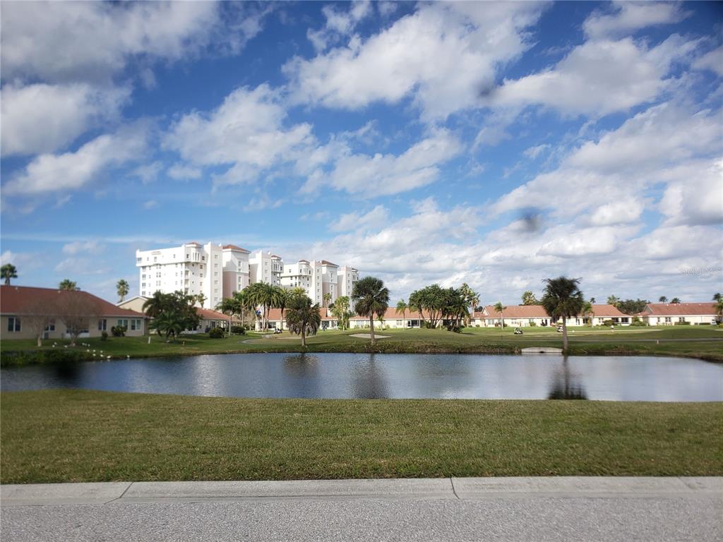 A view of a pond and golf course with residential buildings under a cloudy sky — 2925 TERRA CEIA BAY BOULEVARD UNIT 2203, PALMETTO, FL