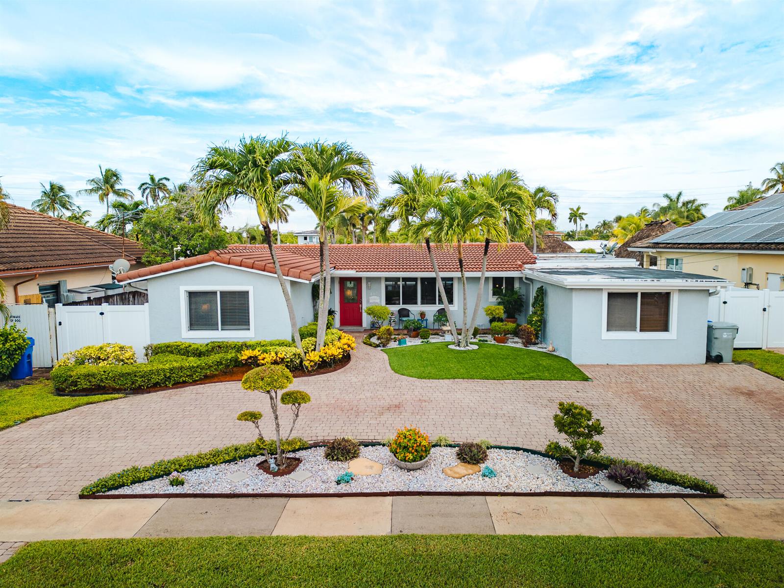 A single-story house with a red door, tile roof, and a paved circular driveway — 801 SE 5th Terrace, Pompano Beach FL 33060, POMPANO BEACH, FL
