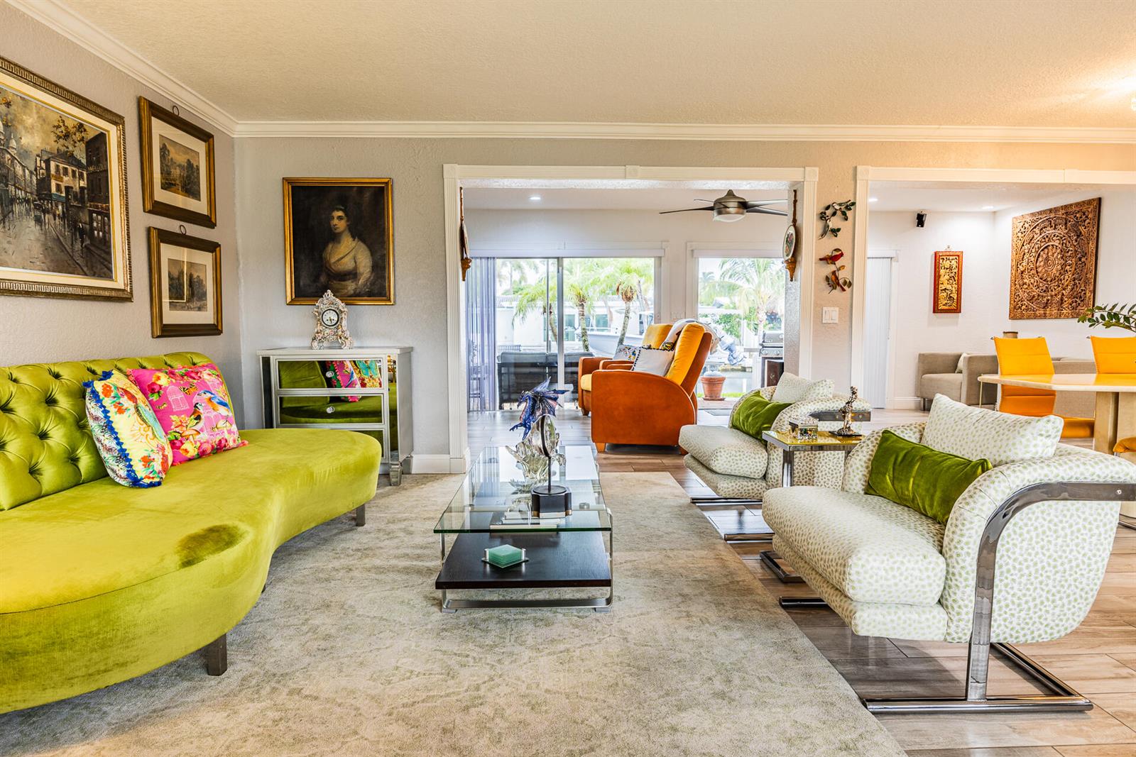 A living room features a lime green sofa, two patterned armchairs, and a glass coffee table — 801 SE 5th Terrace, Pompano Beach FL 33060, POMPANO BEACH, FL