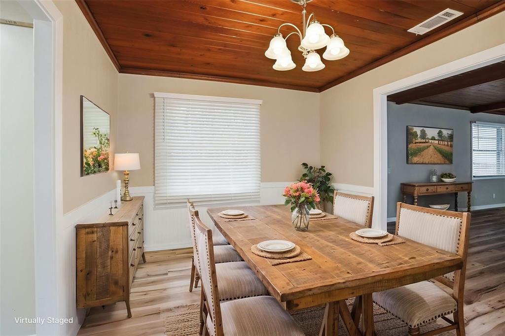 A dining room features a wooden ceiling, light-colored walls, and a rustic wooden table — 65 MARKHAM LANE, BROOKSVILLE, FL