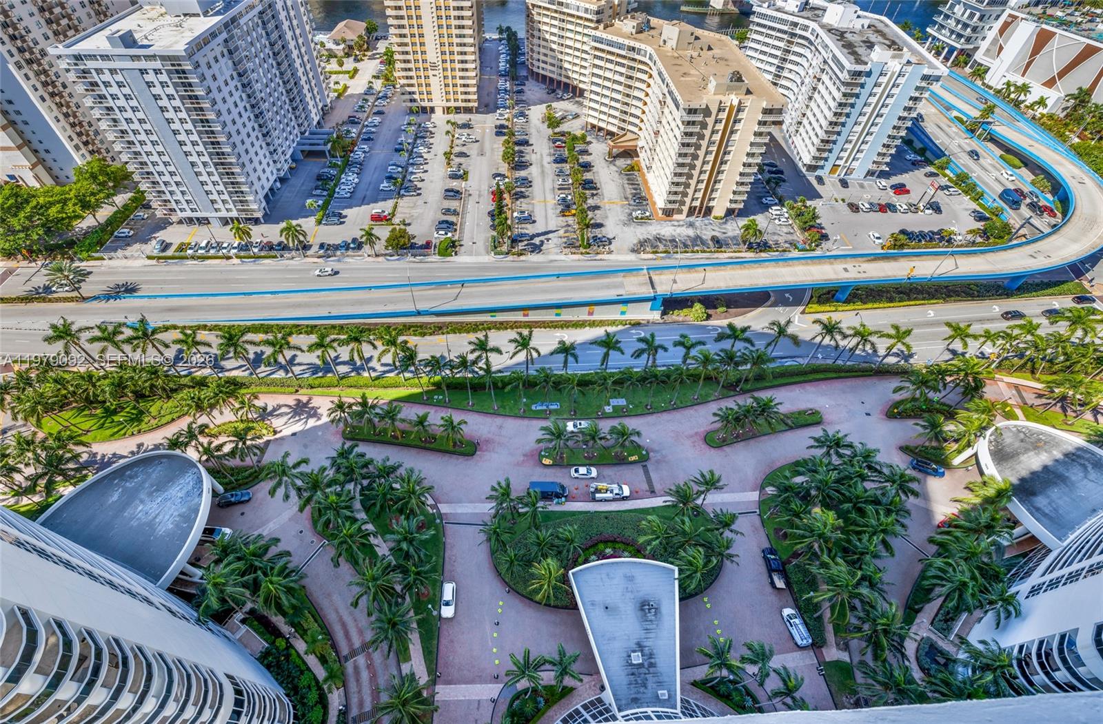 An aerial view shows high-rise apartment buildings, a parking lot, and a multi-lane highway — 1830 S Ocean Dr # 2806, Hallandale Beach FL 33009, HALLANDALE BEACH, FL