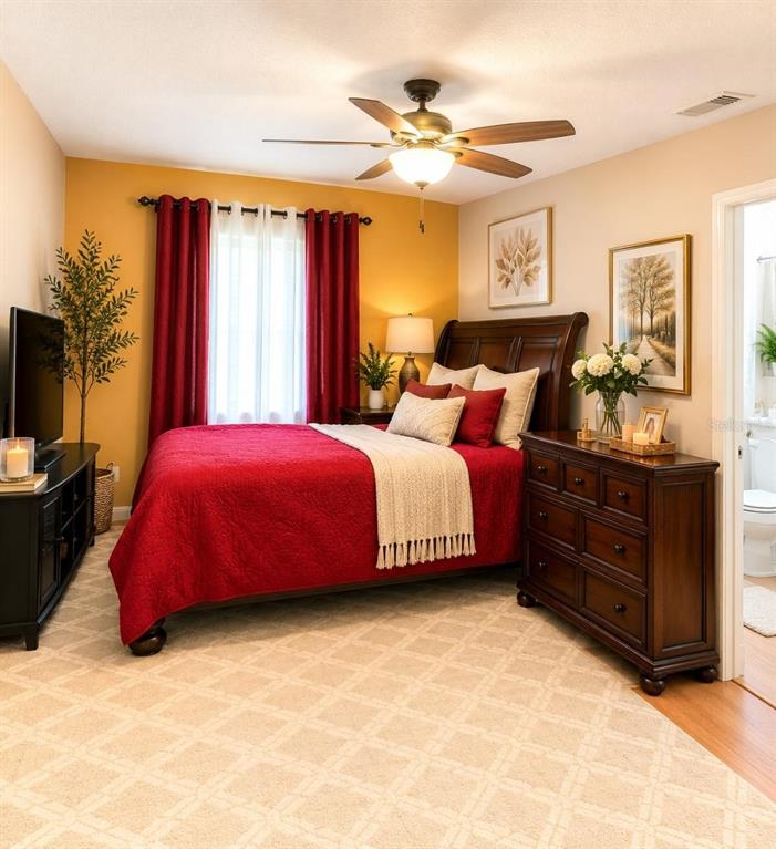 A kitchen with wood cabinets and a breakfast bar featuring two black bar stools — 172 PINEWOOD CIRCLE, KISSIMMEE, FL