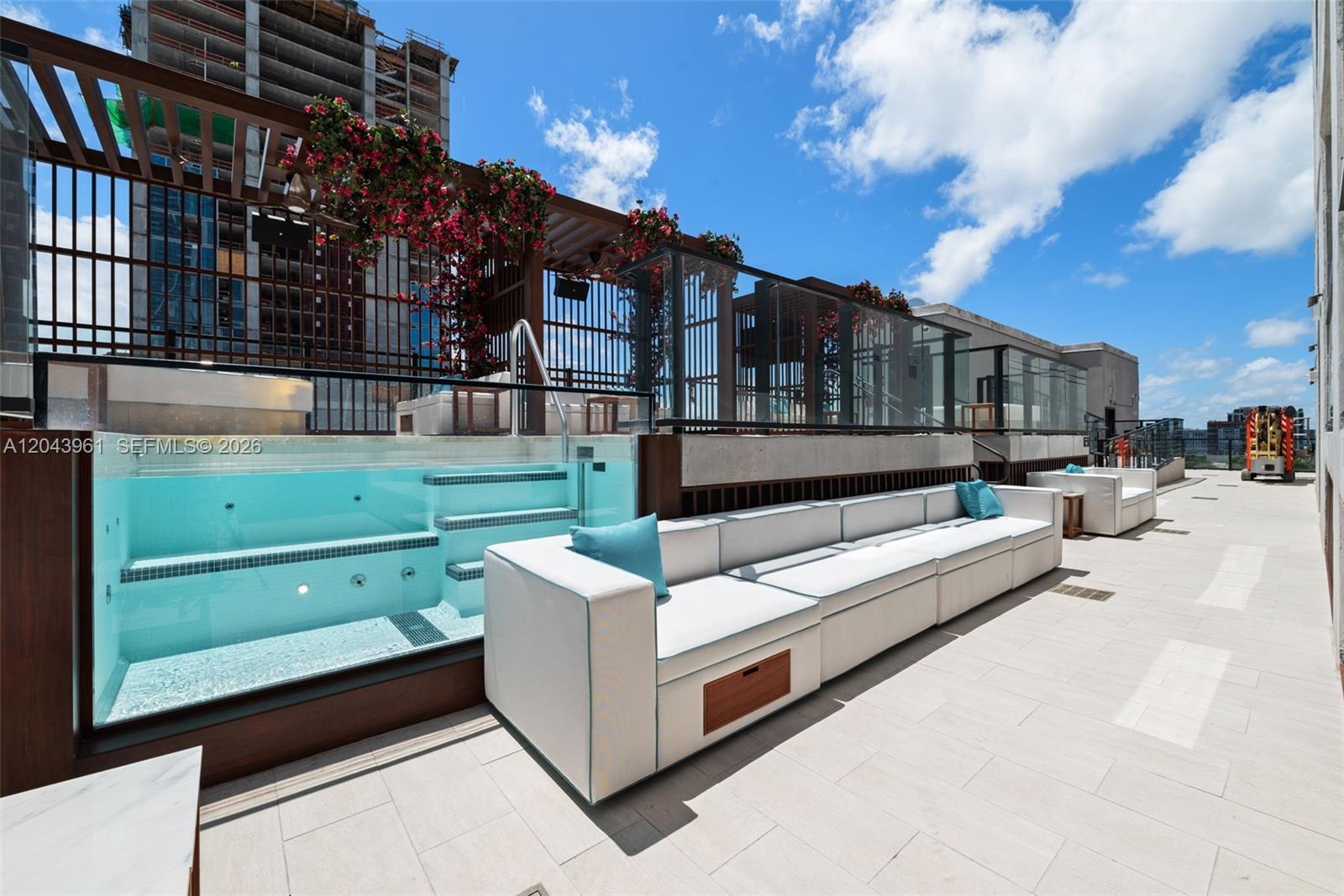 A rooftop terrace features a glass-walled pool, modular white seating, and a wooden pergola — 20 NE 11th Street # 4003B, Miami FL 33132, MIAMI, FL