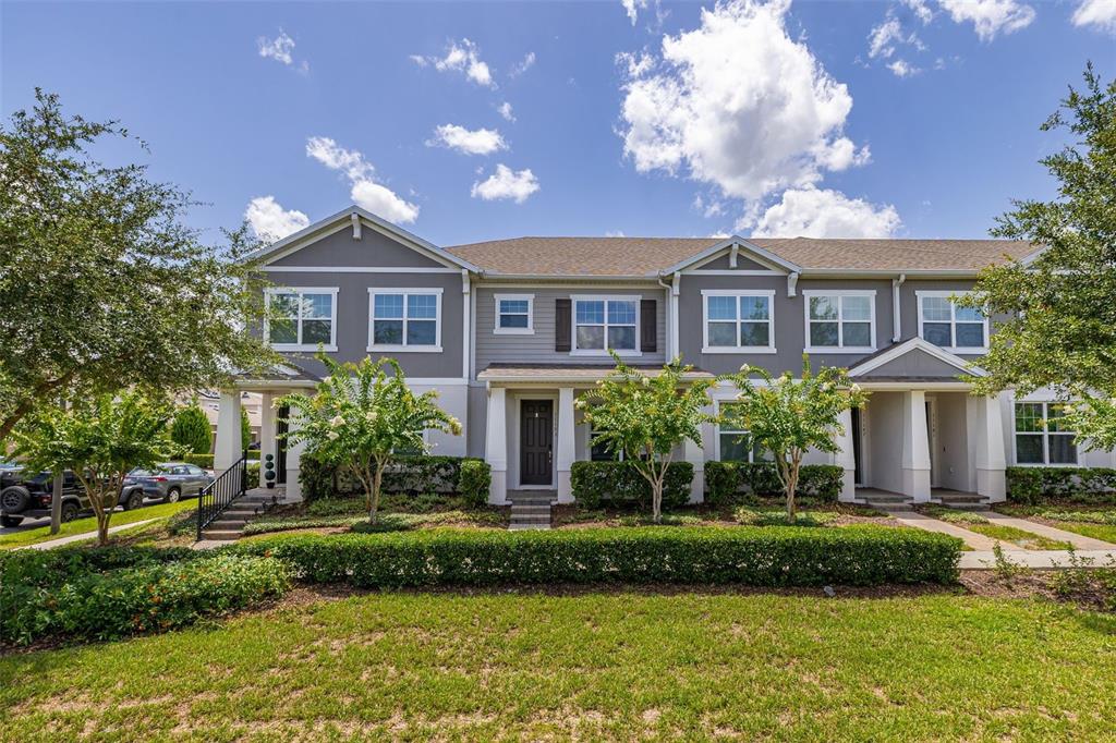 A two-story townhouse exterior features gray siding, white trim, and a manicured front lawn — 11193 HANLON TERRACE ALLEY, WINTER GARDEN, FL