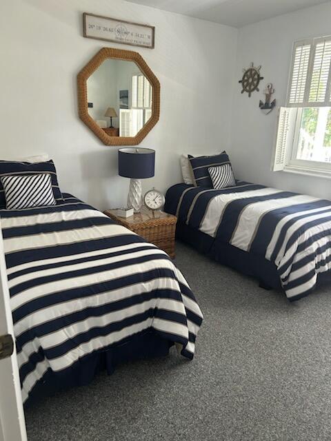 A bedroom features two twin beds with navy and white striped bedding and a wicker nightstand — 2760 Banyan Road # 25a, Boca Raton FL 33432, BOCA RATON, FL