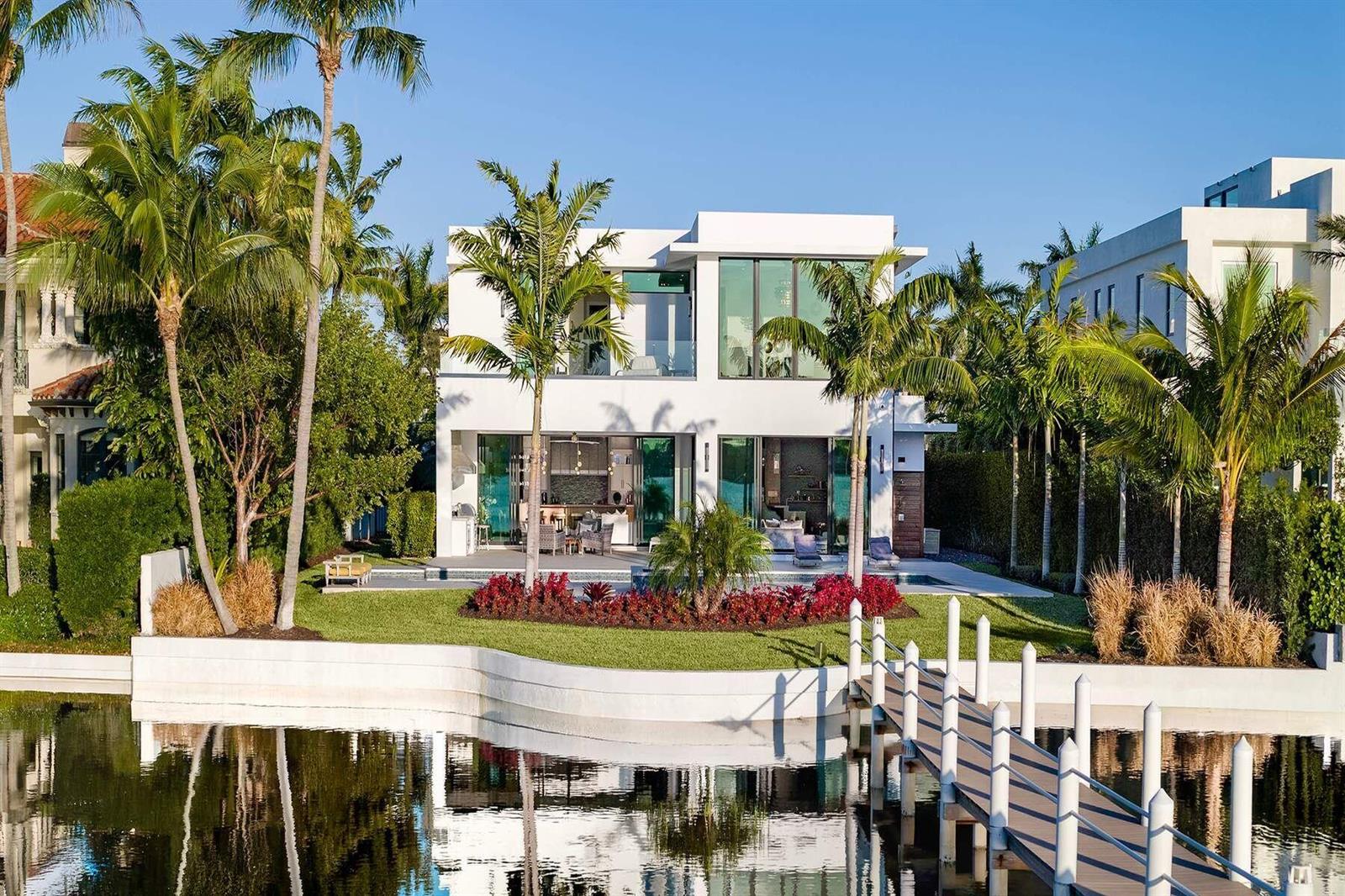 A modern white two-story house with a pool, palm trees, and a dock on water — 807 N Atlantic Drive, Lantana FL 33462, LANTANA, FL