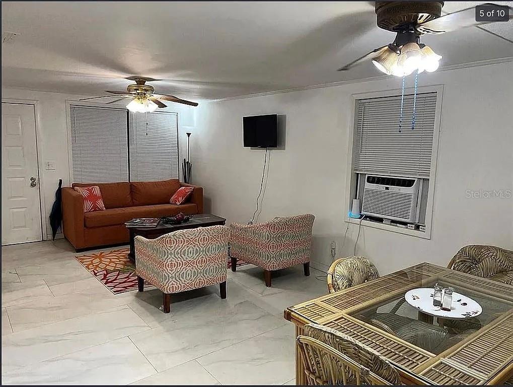 A backyard deck features a fire pit, outdoor seating, a tiki bar, and string lights — 1735 TIMOCUAN WAY, LONGWOOD, FL