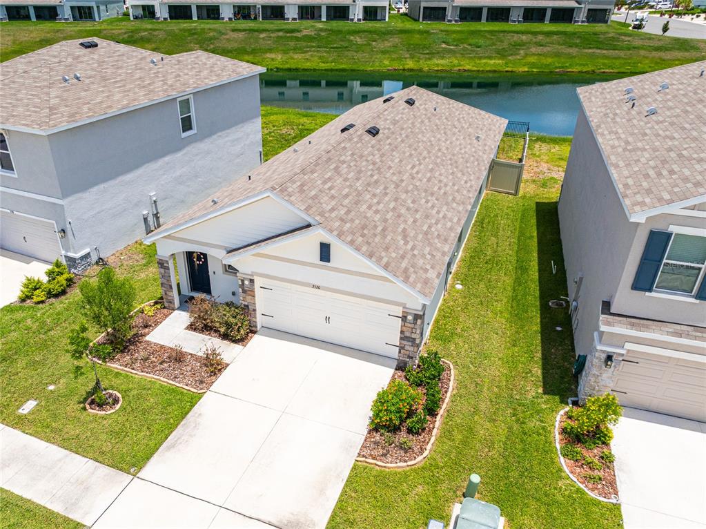 An aerial view shows a single-story house with a tan roof, white garage, and landscaping — 3520 MAPLE GROVE WAY, PLANT CITY, FL