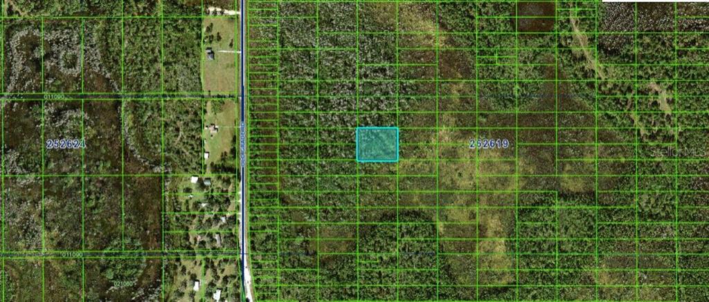 This is an aerial map showing a highlighted rectangular plot of land near a road — OLD GRADE RD, POLK CITY, FL