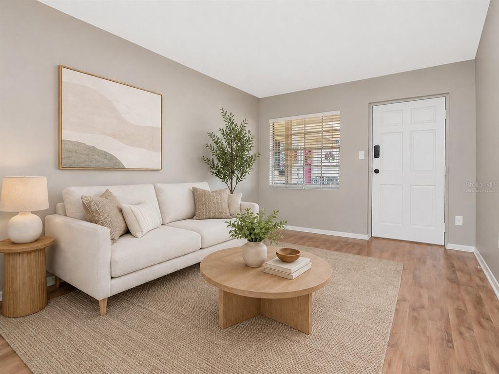A kitchen features white cabinets, stainless steel appliances, and light wood-look flooring — 2207 S CAROLINA AVENUE UNIT 30, TAMPA, FL