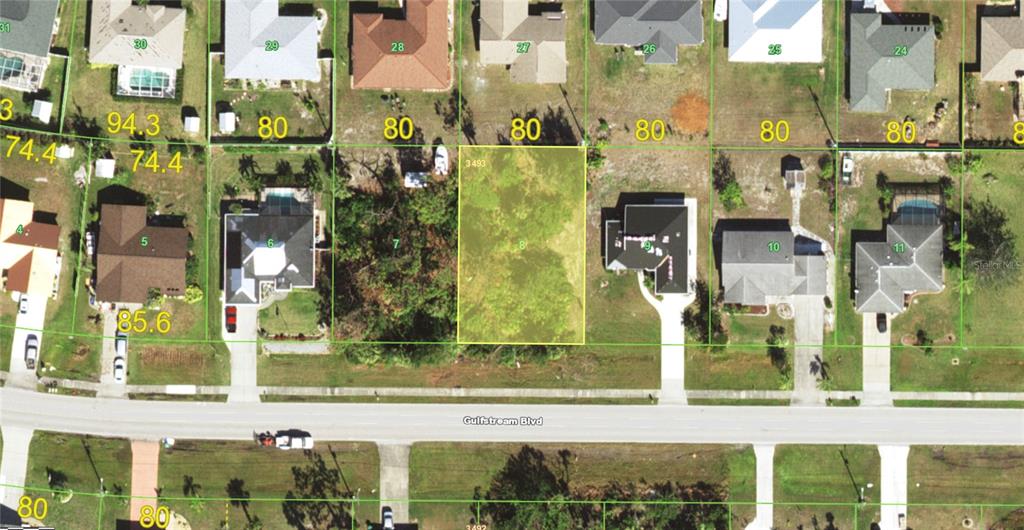 This is an aerial map showing a vacant residential lot highlighted in yellow — 9894 GULFSTREAM BOULEVARD, ENGLEWOOD, FL
