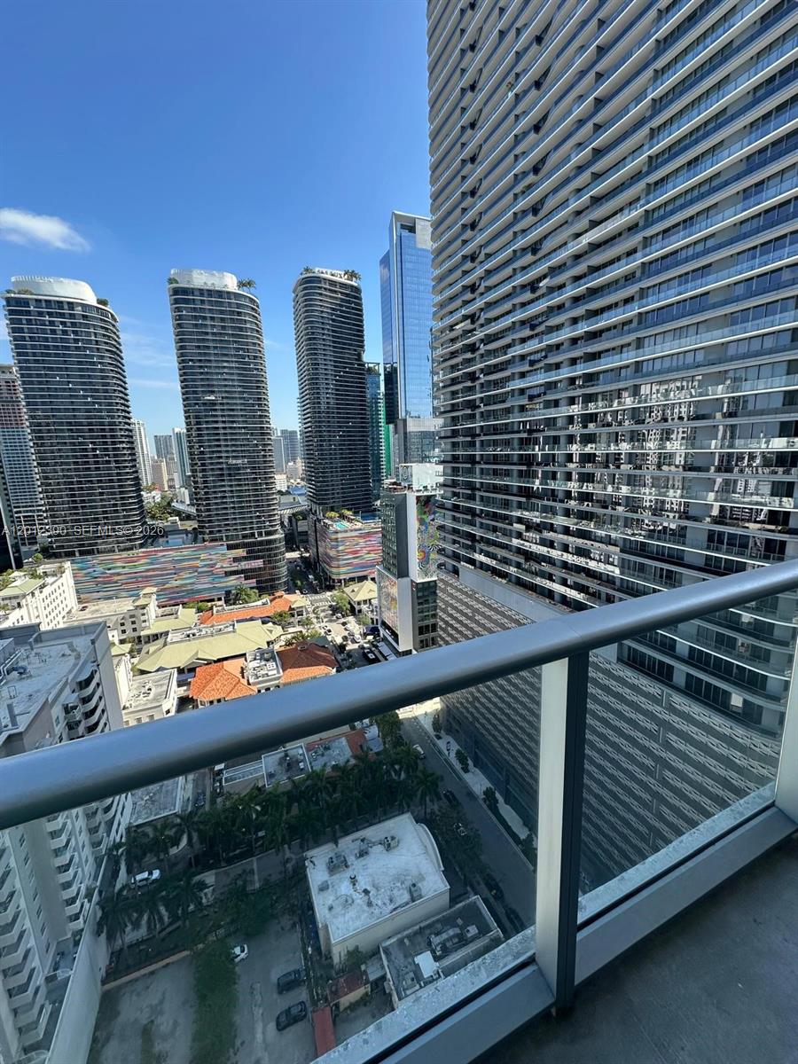 A high-angle view from a balcony overlooking a dense urban skyline with modern skyscrapers — 1100 S Miami Ave # 2608, Miami FL 33130, MIAMI, FL