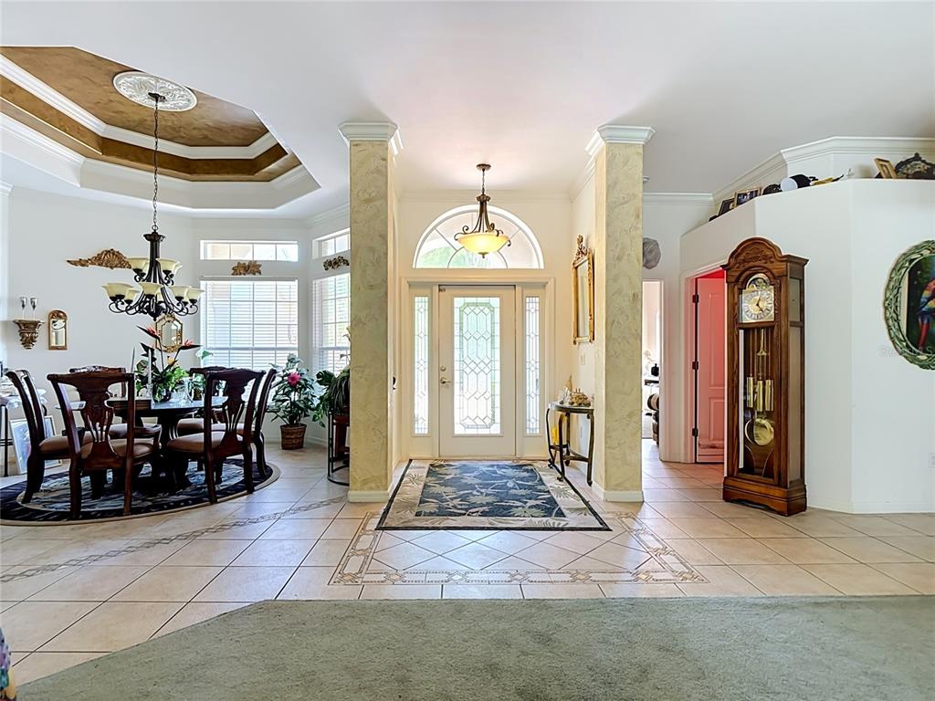 An entryway with a front door, two columns, a dining area, and a grandfather clock — 2221 OXFORD RIDGE CIRCLE, LEHIGH ACRES, FL