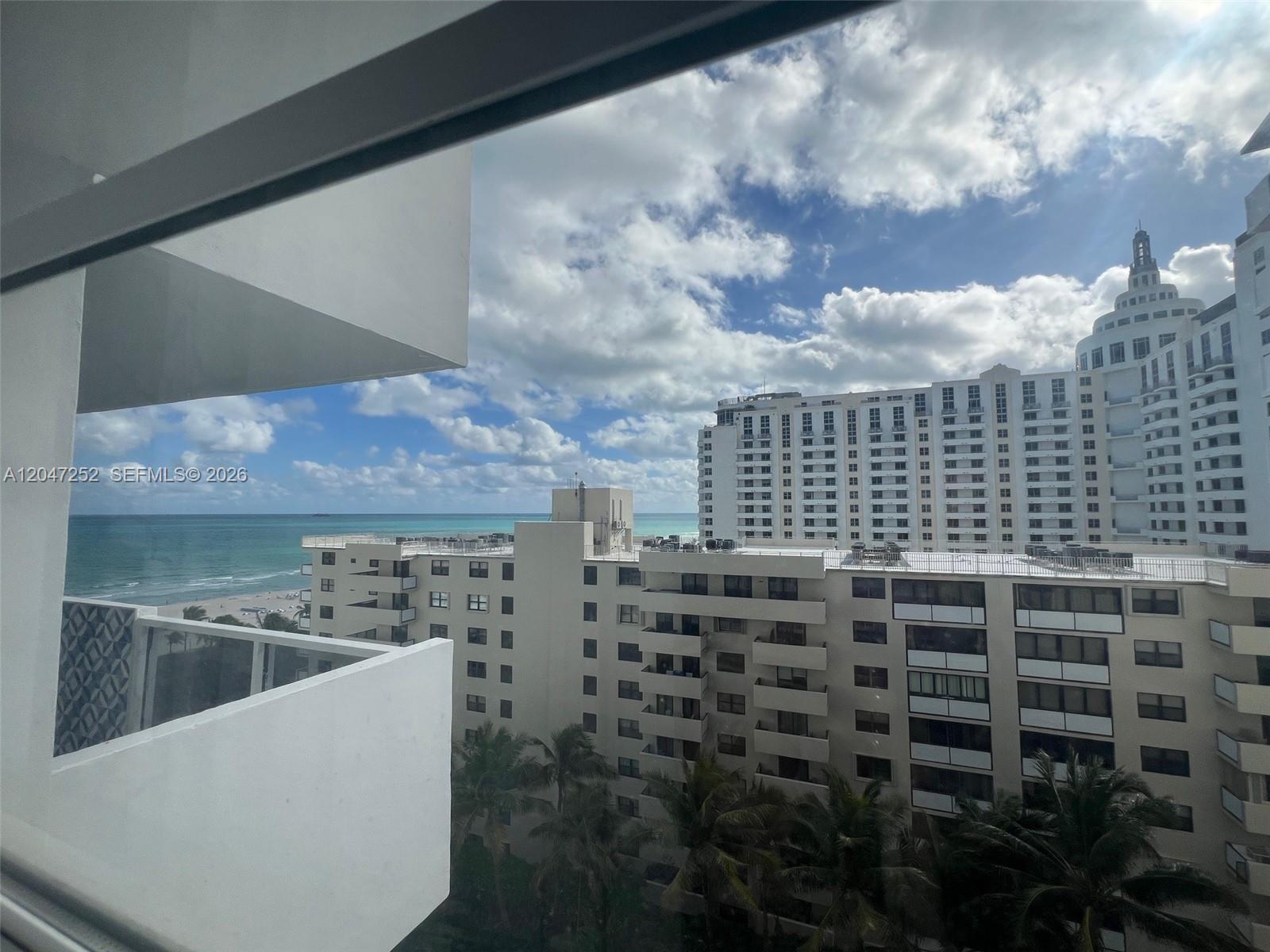 A view from a balcony overlooking a beach and nearby high-rise buildings — 100 Lincoln Rd # 1126, Miami Beach FL 33139, MIAMI BEACH, FL