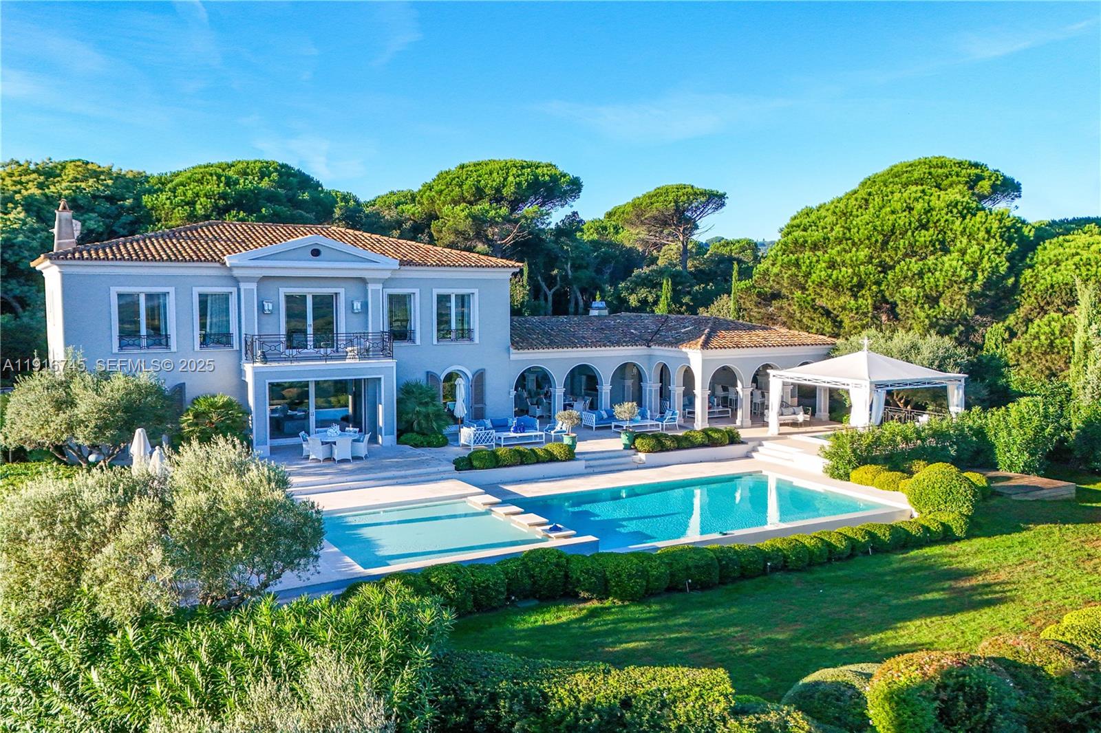 An aerial view shows a two-story villa with a pool, patio, and surrounding garden — La quessine Le Paradis, FL, FL