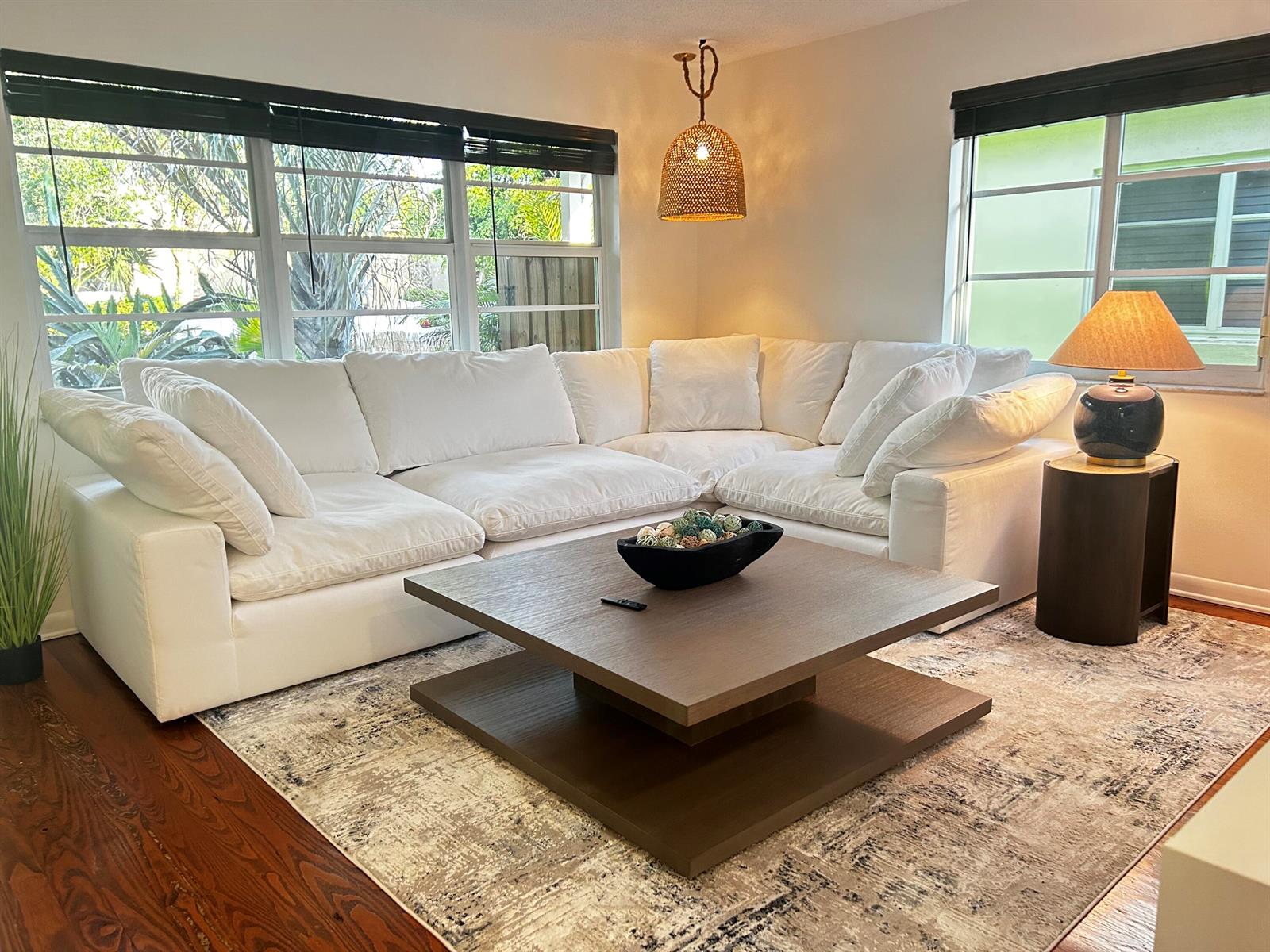 A living room features a white sectional sofa, a square wooden coffee table, and windows — 408 N J Street, FL 33460, FL
