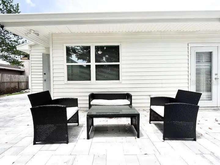 A patio features a black wicker furniture set on a light-colored tiled surface — 3606 W BAY TO BAY BOULEVARD, TAMPA, FL