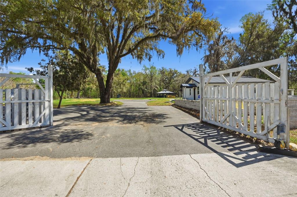 A kitchen with light wood cabinets, stainless steel appliances, granite countertops, and gray wood flooring — 15458 SNOW MEMORIAL HIGHWAY, BROOKSVILLE, FL