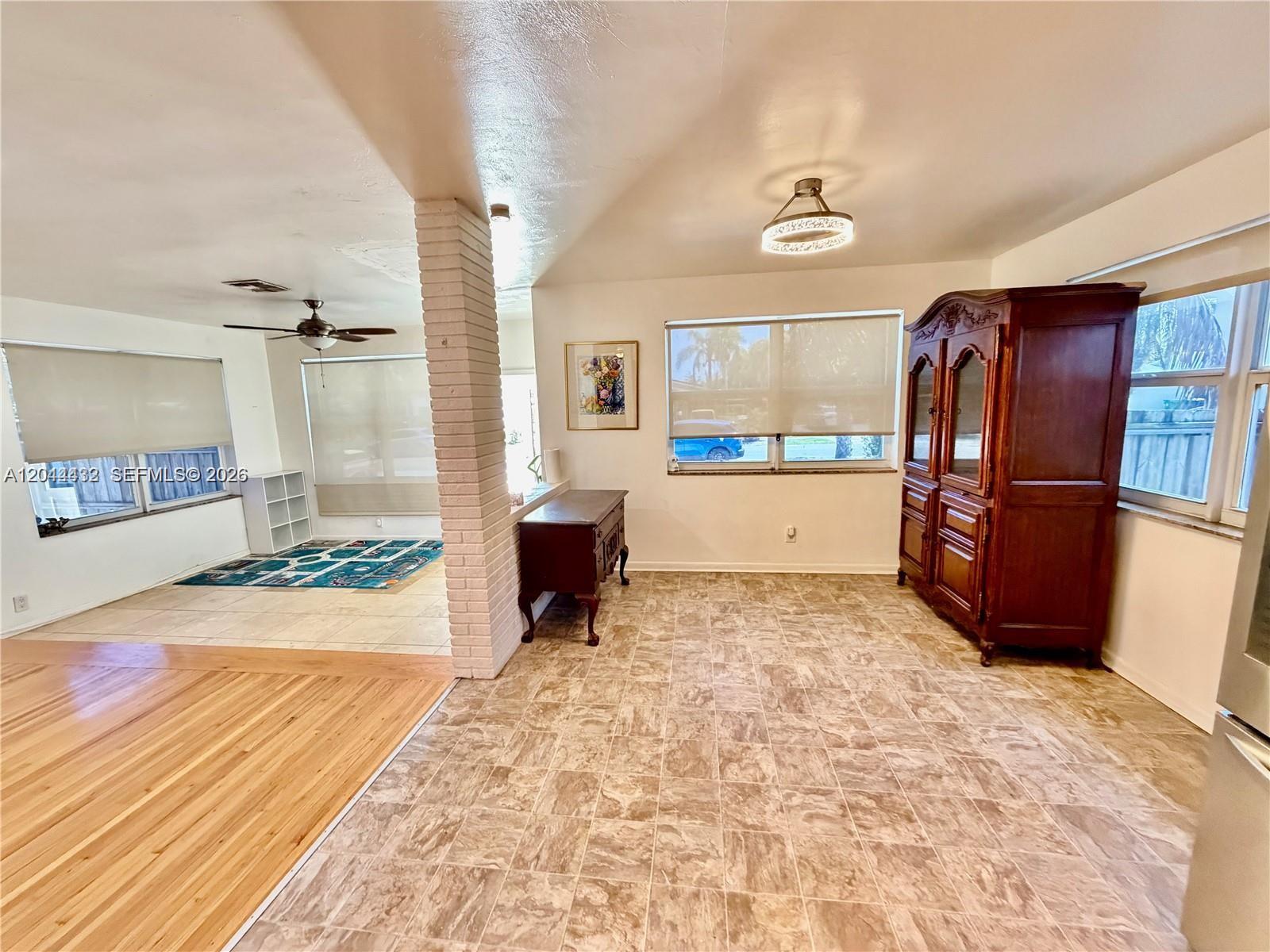 A room with tile flooring, a brick pillar, and a large wooden cabinet — 45 SE 14th St, Dania Beach FL 33004, DANIA BEACH, FL