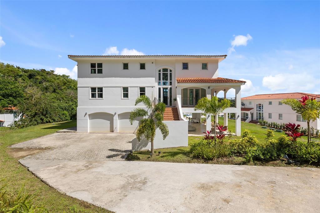 A three-story white house with a tiled roof, arched entryway, and attached garage — Carretera PR-175 KM. 4.0 ESMERALD LAKE PLANTATION UNIT E-3, TRUJILLO ALTO, PR