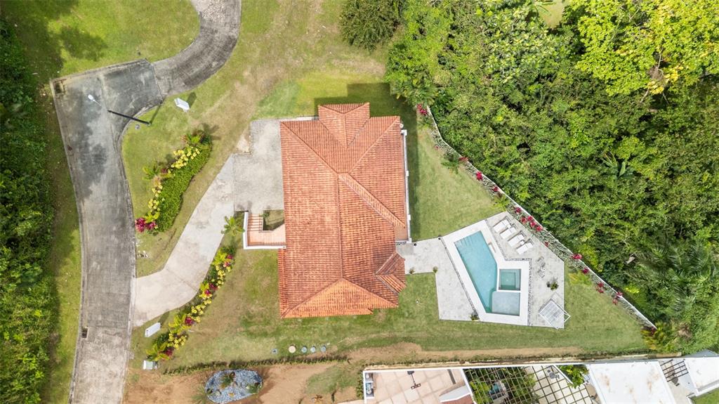 An aerial view shows a house with a red tile roof, pool, and surrounding landscaping — Carretera PR-175 KM. 4.0 ESMERALD LAKE PLANTATION UNIT E-3, TRUJILLO ALTO, PR