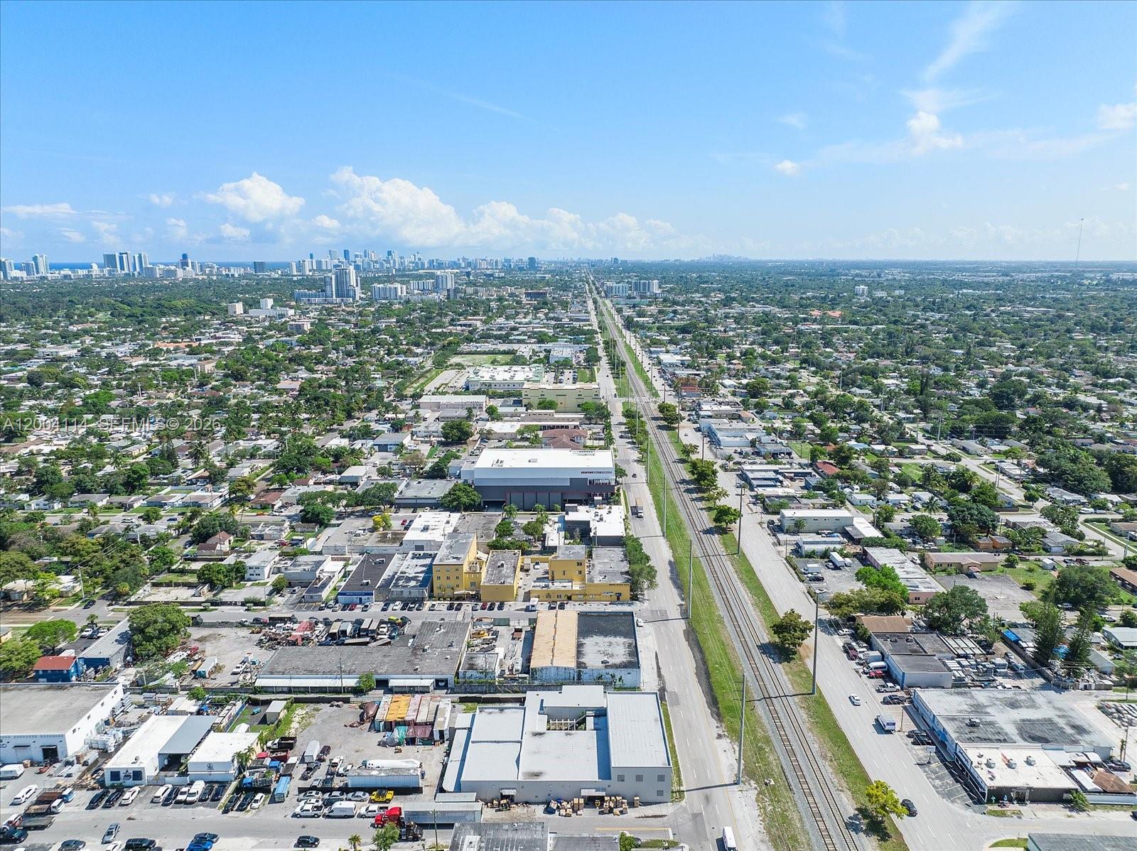 An aerial view shows a commercial and industrial area with railroad tracks and city buildings — 2040 Liberty St, Hollywood FL 33020, HOLLYWOOD, FL