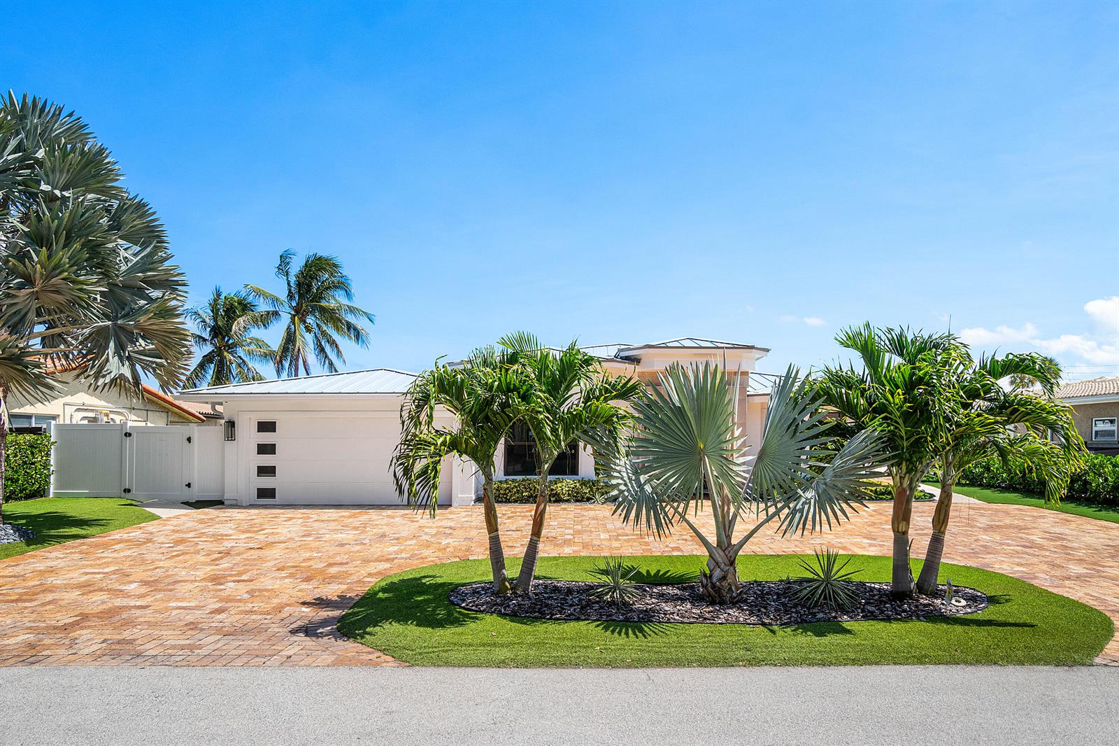 A single-story house with a white garage and palm trees in the front yard — 680 NE Harbour Drive, Boca Raton FL 33431, BOCA RATON, FL